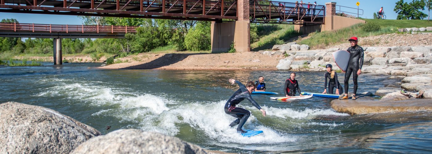 Adults Surfing at River Run